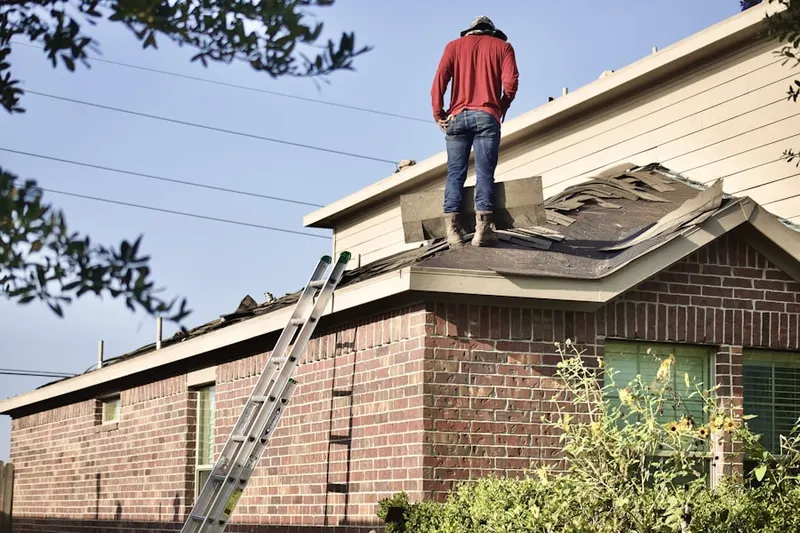 Professional roofer working on a residential roof in Manchester Estates